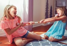 Image: Two girls tugging on a toy