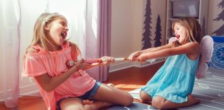 Image: Two girls tugging on a toy