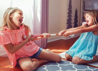 Image: Two girls tugging on a toy