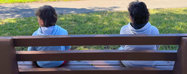 Image: Two children sitting on a park bench