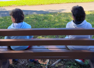 Image: Two children sitting on a park bench