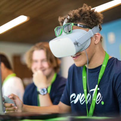 iD Tech Guide Graphic, 2026 Summer Camps Guide Image: A young man demonstrating VR at iD Tech summer camp