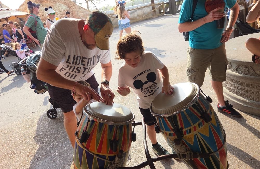 Image: A father and son play some African drums at EPCOT