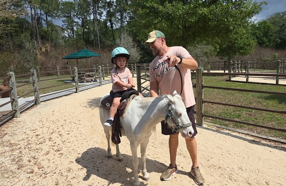 Image: A father and son experience a pony ride at Tri-Circle-D Ranch in Orlando