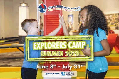 Image: Two children high five during Explorers Camp at Miami Children's Museum