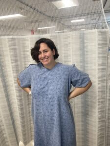 Image: A woman with a hospital gown waiting to have a port placed