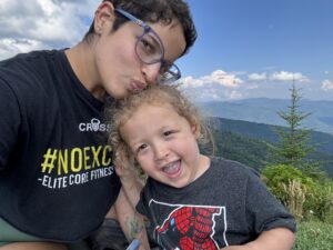 Image: A mom and her son with mountains in the background