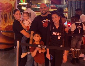 Image: A family poses for a photo at a Miami Heat event