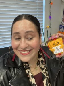 Image: Jackie holds a small crocheted slice of pizza