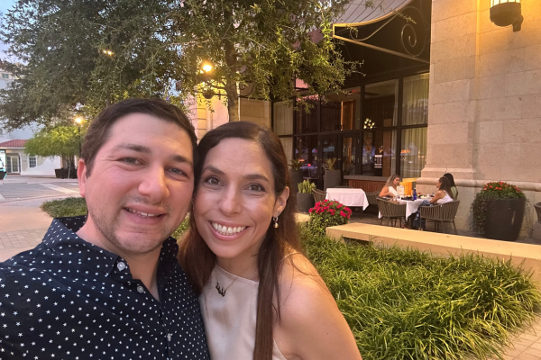 Image: Two people smiling in front of restaurant 