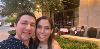 Image: Two people smiling in front of a restaurant