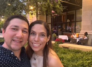 Image: Two people smiling in front of a restaurant