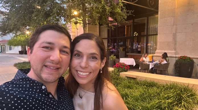 Image: Two people smiling in front of a restaurant
