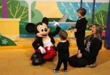 Image: Mom of two with her boys and Mickey Mouse at Walt Disney World