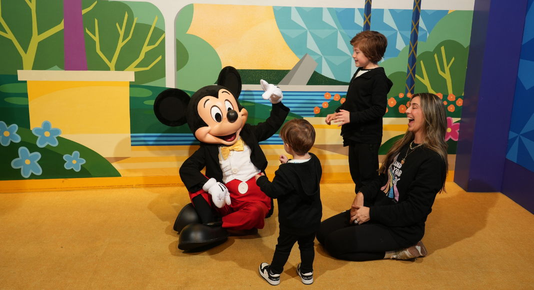 Image: Mom of two with her boys and Mickey Mouse at Walt Disney World