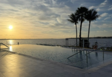 Image: A sunset view of the infinity pool at voco Sandpiper Bay All-Inclusive Resort