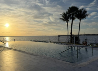 Image: A sunset view of the infinity pool at voco Sandpiper Bay All-Inclusive Resort