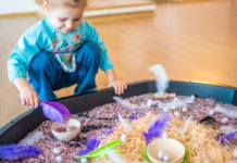 Image: A little girl plays with a large sensory mat