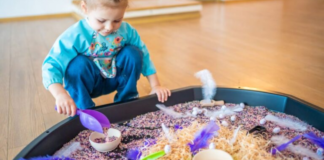 Image: A little girl plays with a large sensory mat