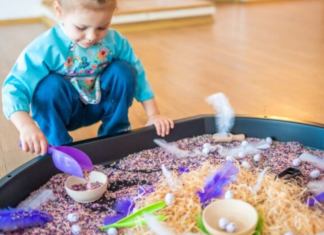 Image: A little girl plays with a large sensory mat