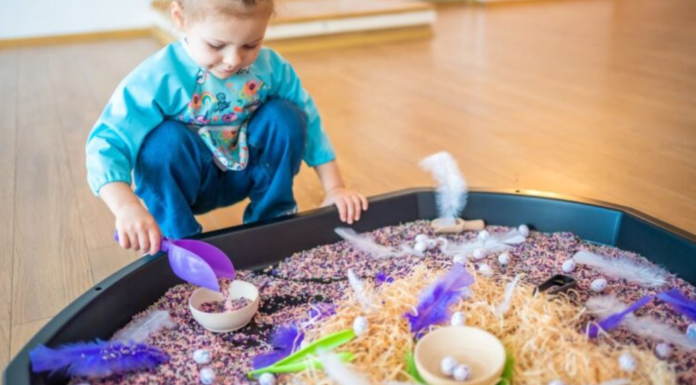 Image: A little girl plays with a large sensory mat