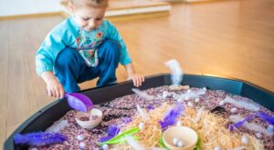 Image: A little girl plays with a large sensory mat
