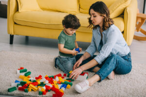 Image: A mother and child playing with Legos