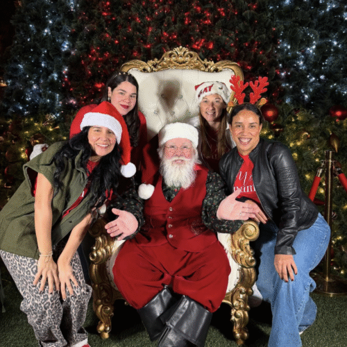 Image: MMC team members pose for a photo with Santa at the Shops at Merrick Park