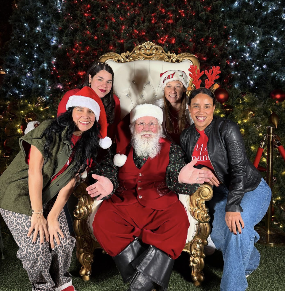 Image: MMC team members pose for a photo with Santa at the Shops at Merrick Park