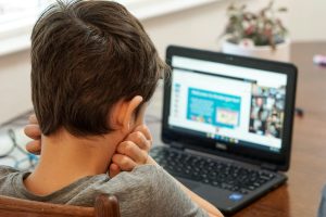 Image: A boy using a device for schoolwork