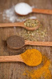 Image: A few wooden tablespoons of different cooking spices