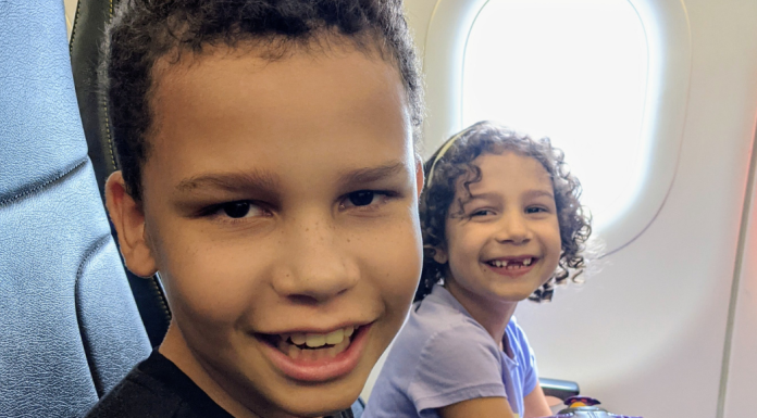Reflections of a Semi-Retired Tooth Fairy: 4 Things I’ve Learned Image: Two kids smiling from their seats on an airplane