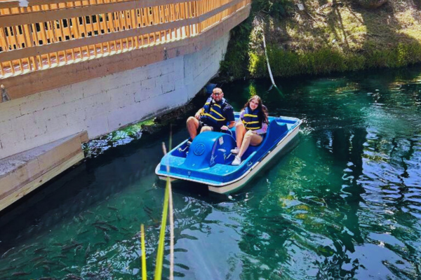 Image: A father and daughter enjoying a paddleboat ride at Pinto's Farm