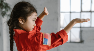 Image: A little girl demonstrates a taekwondo pose