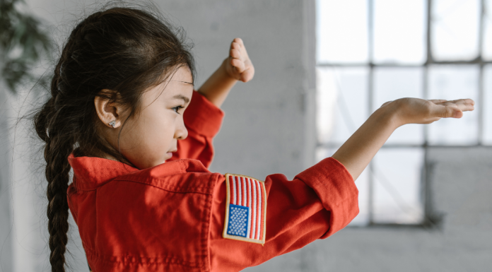 Image: A little girl demonstrates a taekwondo pose
