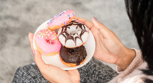 Image: A woman holding a plate of donuts