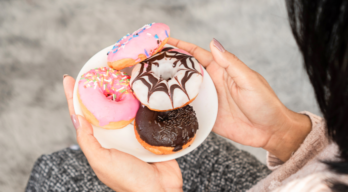 Image: A woman holding a plate of donuts