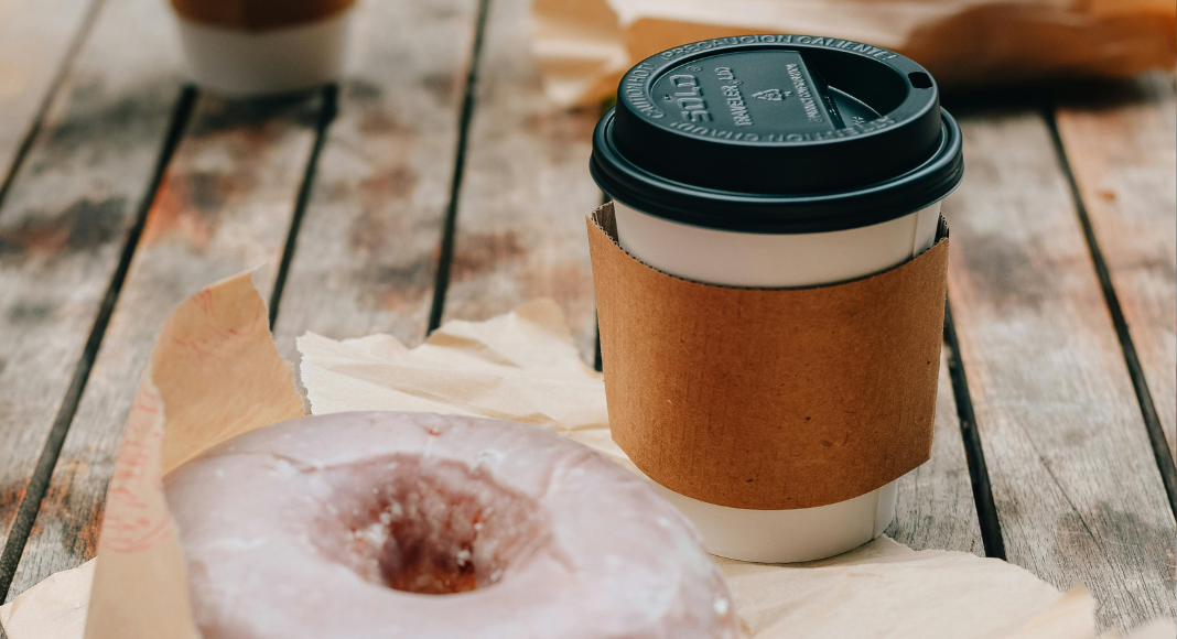 Image: A glazed donut and a cup of coffee