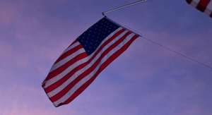 Image: An American flag flies against a blue sky