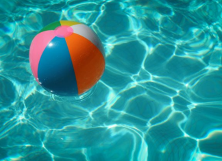 Image: A colorful beach ball floats in a swimming pool