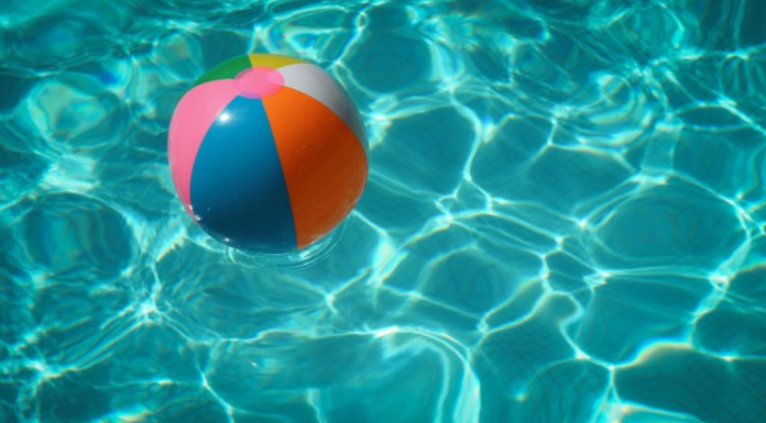Image: A colorful beach ball floats in a swimming pool
