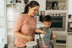 Mom and child share the family tradition of cooking together