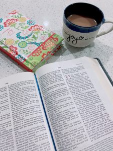 Image: A journal, cup of coffee, and an open Bible on a countertop