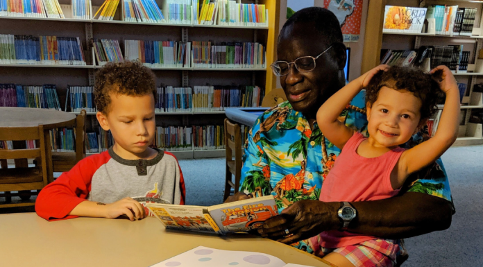 Visiting the Dentist: 15-ish Books for Kids | Dr. Bob Image: A grandfather reads books to his grandchildren at the library