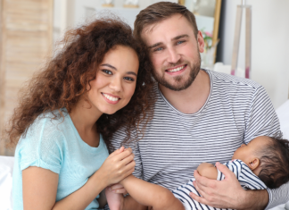 Image: Parents holding their infant