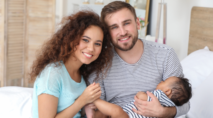 Image: Parents holding their infant