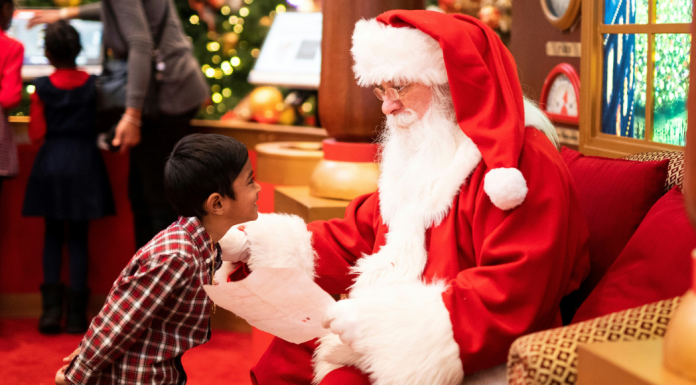 Image: A little boy shares his Christmas list with Santa