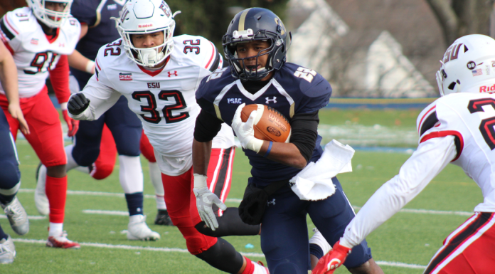 Image: A football player runs the ball down the field