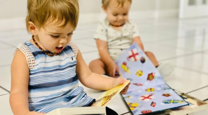 Two toddlers reading
