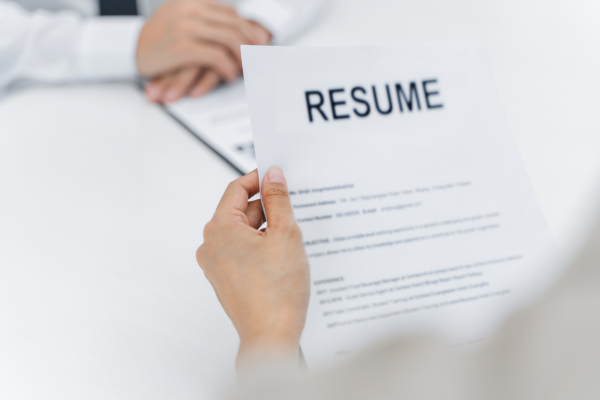 Image: Someone reviews an applicant's resume